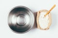 Empty metal bowl and pack of flour Royalty Free Stock Photo