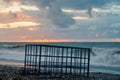 Empty metal cage on the sunset beach Royalty Free Stock Photo