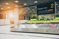 Empty metal conveyor belt with baggage claim sign in arrival hall area at the airport Royalty Free Stock Photo