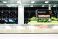 Abstract blurred empty metal conveyor belt with baggage claim sign in arrival hall area at the airport for background Royalty Free Stock Photo