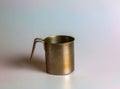 Empty metal cup of unusual shape on a white background Royalty Free Stock Photo