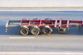 Empty metal frame trailer transporting goods on highway