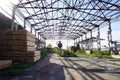 Empty metal-frame warehouse with timber stacks. Royalty Free Stock Photo