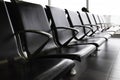 Empty metal seats with black leather seat in the public area at an airport