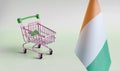 An empty metal shopping basket and the flag of the Republic of Ivory Coast on a light background is a concept of consumption