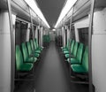 An empty metro interior without people. The seats are on both sides.