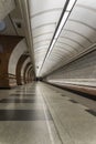 Empty metro station, lonely people on long platform.