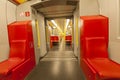 Empty metro train interior with red seats, city transport