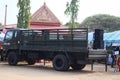 An empty military truck parked in an open-air courtyard, selectable focus.