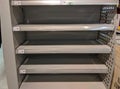 Empty milk shelves in supermarket after panic buying due to outbreaking coronavirus translation:`There is no stock available due t