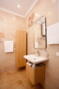 Empty minimalistic interior background, bathroom of modern apartment, mirror and basin in light colors