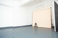 Empty minimalistic photography studio with a chair under the lights - fashion concept