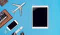 Empty mobile tablet screen for mock up in travel concept with travel gadget on blue Royalty Free Stock Photo