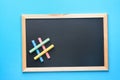 Empty Mock Up Black Chalkboard with Hashtag Sign Made from Multicolored Chalks Blue Background. Back to School Concept Education
