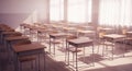 Empty modern classroom with neat rows of wooden desks and chairs illuminated by natural light through large windows with white Royalty Free Stock Photo
