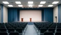 Empty modern conference hall with two podiums on stage, large screen, and rows of seats, ready for an event Royalty Free Stock Photo