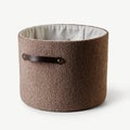 Empty modern cylinder shaped boucle storage basket with leather handle Royalty Free Stock Photo