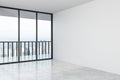 Empty modern hall with concrete floor, mock up wall and big window with city view in the afternoon Royalty Free Stock Photo