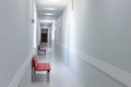 Empty modern hospital corridor, clinic hallway interior background with red chairs for patients waiting for doctor visit Royalty Free Stock Photo