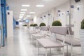 Empty modern hospital corridor, clinic hallway interior background with white chairs for patients waiting for doctor visit. Royalty Free Stock Photo