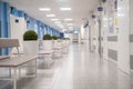 Empty modern hospital corridor, clinic hallway interior background with white chairs for patients waiting for doctor visit. Royalty Free Stock Photo