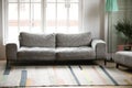 Empty modern living room with comfortable grey couch and carpet Royalty Free Stock Photo