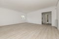 Empty modern living room with white painted walls, double access door, small window on a wall with wooden floors and light parquet Royalty Free Stock Photo