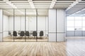 An empty, modern meeting room with a table, chairs, and stylish lighting on a wooden floor background, concept of a corporate Royalty Free Stock Photo