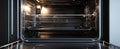 The empty modern oven showcasing sleek steel interior and design features..AI generated image Royalty Free Stock Photo