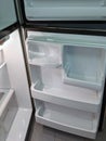 Empty, modern refrigerator with opened doors. Inside of a clean fridge with plastic shelves