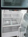 Empty, modern refrigerator with opened doors. Inside of a clean fridge with plastic shelves