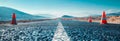 Empty Modern Road Under Construction with Traffic Cones and Scenic Mountain View - Concept of Development Royalty Free Stock Photo