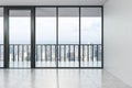 Empty modern spacious hall with concrete floor, big window with city view in the afternoon Royalty Free Stock Photo