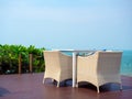 Empty modern white rattan furniture, outdoor garden weave table set. Royalty Free Stock Photo