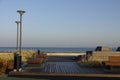 Empty modern wooden bench on the Reidi promenade (estonian Reidi tee) on the shore of Baltic sea. Cloudy summer day