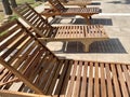 Empty modern wooden sunbeds by turquoise swimming pool. cyprus. empty hotel in quarantine period before opening Royalty Free Stock Photo