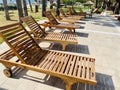 Empty modern wooden sunbeds by turquoise swimming pool. cyprus. empty hotel in quarantine period before opening Royalty Free Stock Photo