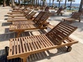 Empty modern wooden sunbeds by turquoise swimming pool. cyprus. empty hotel in quarantine period before opening Royalty Free Stock Photo