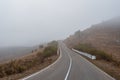 Empty morning mountain highway in a dense fog. Road through a dense fog