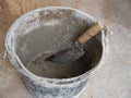 Empty mortar bucket and dirty trowel