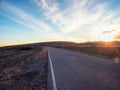 Empty mountain highway at sunset. Asphalt road and sky clouds at sunset.Road background Royalty Free Stock Photo