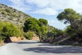 Empty mountain road with blue sky and sea on a background. Greece, island of Salamina. Royalty Free Stock Photo