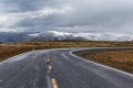 Empty mountain road on a cloudy winter day. Royalty Free Stock Photo