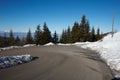 Empty mountain road curve on Alps with pine trees and snow Royalty Free Stock Photo