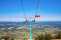 Empty mountain ski chairlift in summer. Forest mountains panorama on the horizon. Travel concept Royalty Free Stock Photo