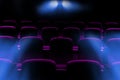 Empty movie theater with purple seats with flare light from projector Royalty Free Stock Photo