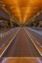 Empty moving walkway in International airport Doha, Qatar. Moving sidewalk in perspective. Airport interior. Travel in quarantine. Royalty Free Stock Photo