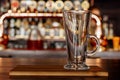 Empty mug standing on a wooden board in a pub. Royalty Free Stock Photo