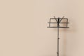 Empty music note stand on color background. Royalty Free Stock Photo