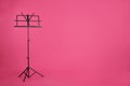 Empty music note stand on color background Royalty Free Stock Photo